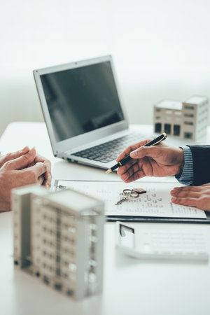 Real estate agents dealing with the leasing of houses and condos are ready to negotiate and discuss the terms of the home purchase contract and ask customers to sign a contract toの写真素材