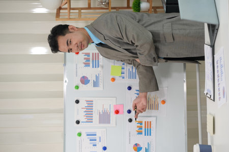 Check financial documents with Asian male accountant calculator Financial planning for expenses within the company is being made. Calculate numbers according to accounting reportsの写真素材