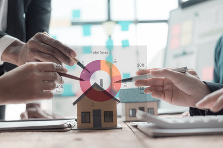 A real estate agent is explaining the layout of a house to a client who is about to buy a new apartment along with insurance interest rates on the title. Close-up photoの写真素材