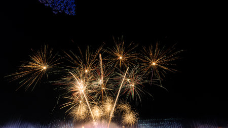 Big fireworks over the city, new year party background, new year, long fireworks on the dark blue night sky surface with beautiful colors.の写真素材