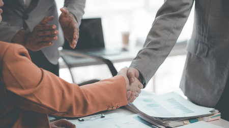 Businessmen shake hands after a meeting Business etiquette. Congratulations. Merger and acquisition...