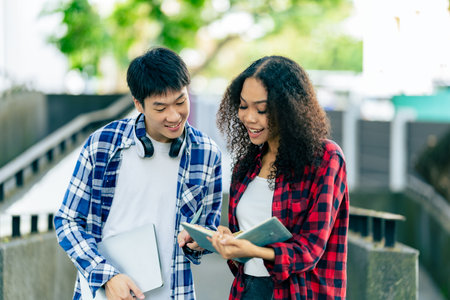 educational campus University students holding laptops talk or talk about exams, books, friends or outdoor variety.の写真素材