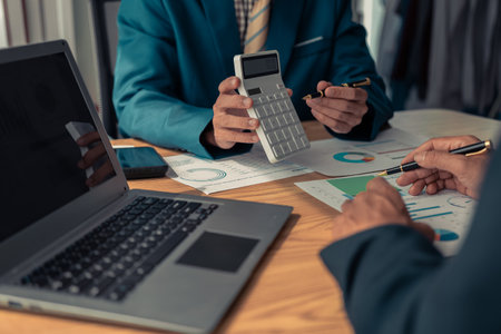 Close-up of Business Colleagues team analyzing financial data at table in modern office on business strategy Group of business people discussing charts and graphs showing successfuの写真素材