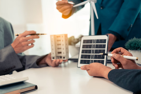 Alternative energy concept, electrical engineer and businessman discussing new solar panel installation project. Close-up picturesの写真素材