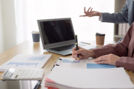 A meeting to review organizational compliance with experts reviewing documents. Investment advisor, strategy, planning, accounting concepts Business advisory group meets to analyzeの写真素材