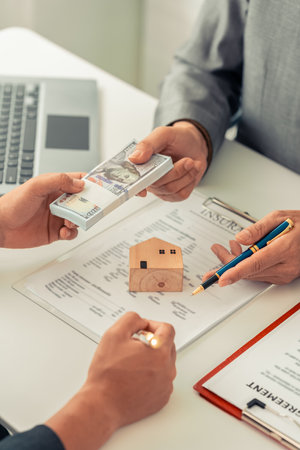Real Estate Purchase Advisory Office Brokers help business partners make financial investments. Mortgage installments, bank loan concept. Vertical format.の写真素材