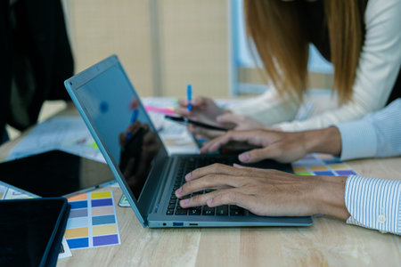 UX/UI designers discuss and brainstorm layouts for website and mobile app prototypes in website and...