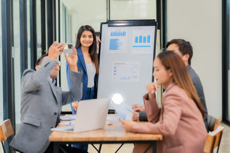 Motivated businessman leads a business meeting with the manager. Speech. Using television presentation with statistics.  Using graphs and charts for effective strategiesの写真素材