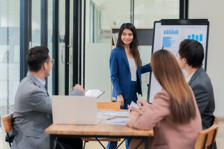 Motivated businessman leads a business meeting with the manager. Speech. Using television presentation with statistics.  Using graphs and charts for effective strategiesの写真素材