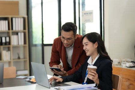 Asian business team working with analytical reports and consultants showing plans, financial analysisの写真素材