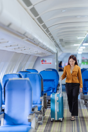 Beautiful Asian woman travels by plane to foreign countries for vacation. The atmosphere inside the plane. A woman makes various poses on the plane.の写真素材