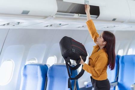Beautiful Asian woman travels by plane to foreign countries for vacation. The atmosphere inside the plane. A woman makes various poses on the plane.の写真素材