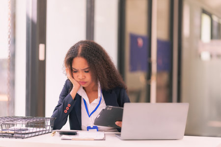 African American young woman working with laptop. Working lifestyle and confidence. Diversity and business success banner.の写真素材