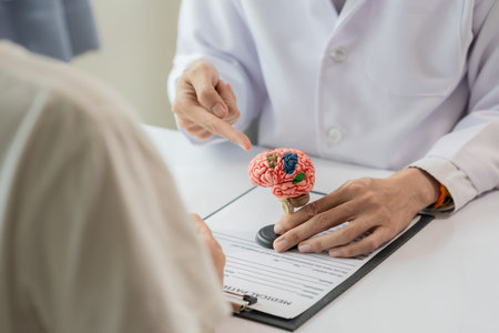 Doctor and patient are discussing something while sitting at the table. Concept of medicine and healthcare. Male doctor explaining diagnosis to female patient. Concept of medicineの写真素材