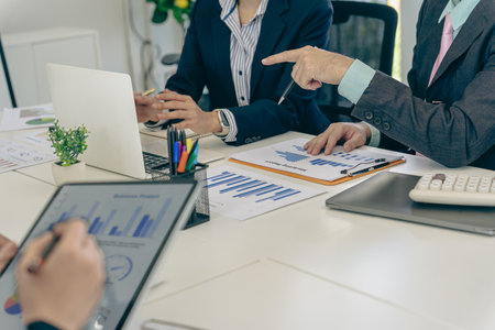 Business people discussing charts and graphs showing the results of successful teamwork. Investment from teamwork. Close-up.の写真素材