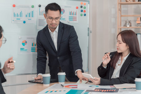 Business team discussing charts and graphs about investment and business growth. Business colleagues...