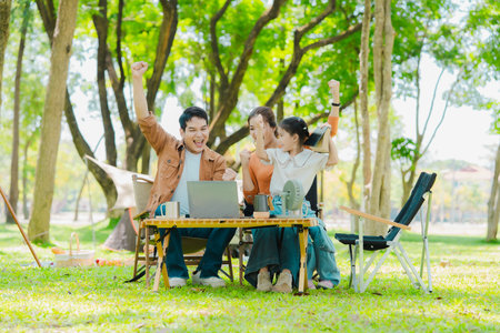 Asian family traveling and camping in the forest feeling happy during family time, adventure and travel concept family activities and outdoor activitiesの写真素材