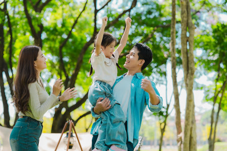 Asian family traveling and camping in the forest feeling happy during family time, adventure and travel concept family activities and outdoor activitiesの写真素材