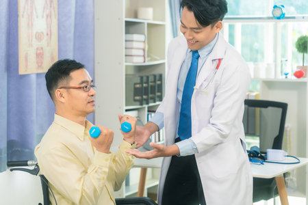 Physical therapy with dumbbells and elderly man with nurse for rehabilitation, support and retirement, health care, medical assistanceの写真素材