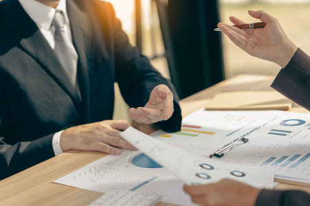 Business people discussing using financial document data charts and graphs. Business meeting. Financial analysis to determine business growth strategy and success.の写真素材