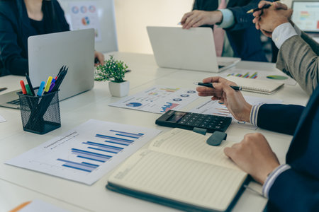 Business people discussing using financial document data charts and graphs. Business meeting. Financial analysis to determine business growth strategy and success.の写真素材