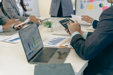 Business people discussing using financial document data charts and graphs. Business meeting. Financial analysis to determine business growth strategy and success.の写真素材