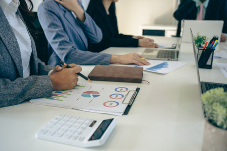 Business people discussing using financial document data charts and graphs. Business meeting. Financial analysis to determine business growth strategy and success.の写真素材