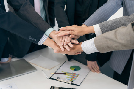 Business people shake hands after a meeting to symbolize cooperation, teamwork to achieve goals and...