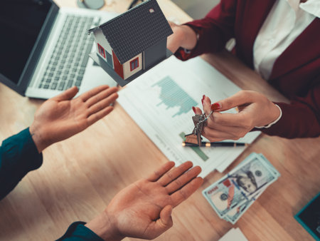 A close agent hands over the keys to the new owner or tenant, the client after signing a lease-purchase agreement, bank contract, real estate mortgage loan.の写真素材