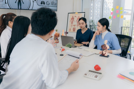 A group of young Asian physicians are talking with colleagues in a medical conference room, discussing and reviewing rare disease cases to improve practice guidelines. Doctorsの写真素材