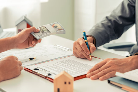 Real estate agent showing house plans to clients. Agent during meeting with interested clients,...