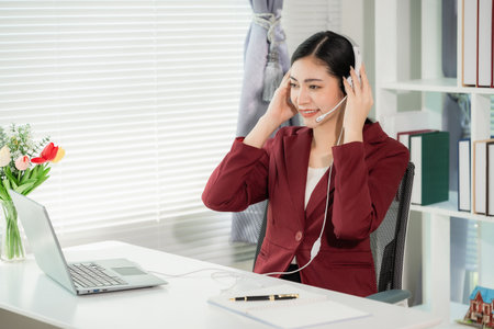 Asian woman professional employee customer service online communication corporate environment using technology in customer serviceの写真素材