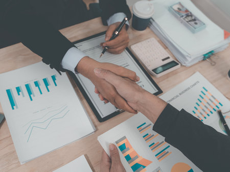 Merger and acquisition concept. Professional businessmen shaking hands after meeting and achieving results. Asian unity and teamwork concept. Team success.の写真素材