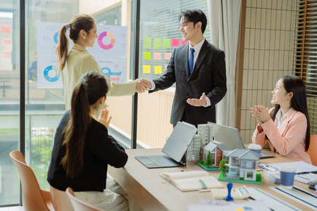 Celebrating success, hands raised in appreciation for real estate development, teamwork, men and women cheering, engineering and company progress.の写真素材