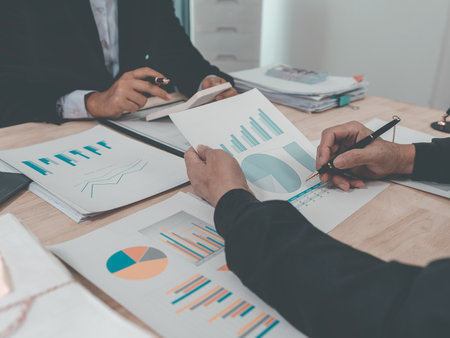 Business people discussing charts and graphs showing the results of successful teamwork, data analysis, efficiency and success of financial planning. Close up.の写真素材