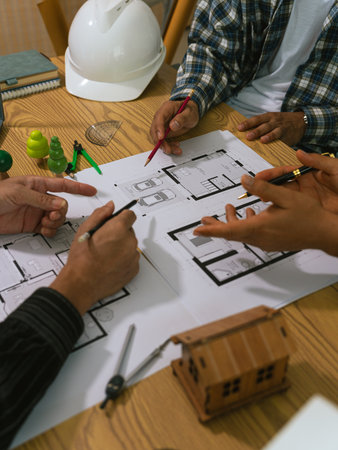Architects working with blueprints at their desks. Architectural concept drawings, sketches and...