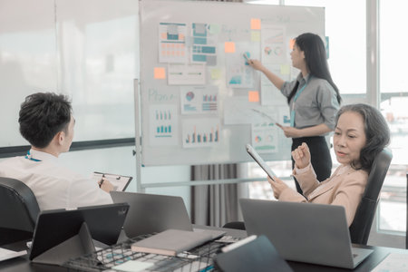 Group of business people discussing charts and graphs showing results of teamwork of colleagues...