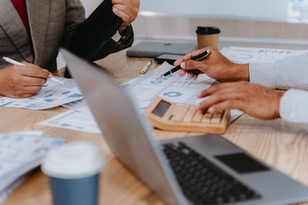 Close up of businessman using calculator to calculate financial data, check financial information, accounting and tax audit concept.の写真素材