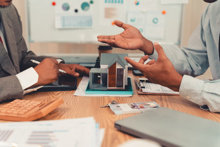 Real estate agent and client sign contract on clipboard on table.の写真素材