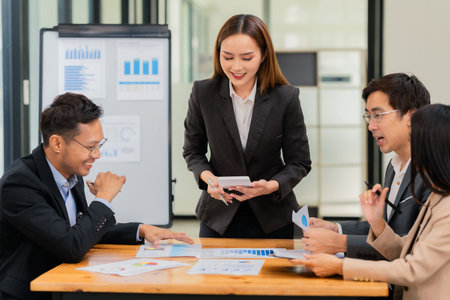 Group of business people discussing business plan in office conference room. Project planning, creative brainstorming, discussing ideas, using documents, digital devices.の写真素材