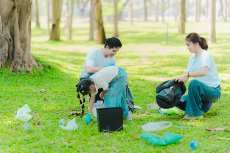 Volunteers are collecting litter to protect the environment. A group of volunteers is cleaning up...
