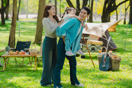 The concept depicts the lifestyle of Asian families enjoying camping together in a park, a concept...