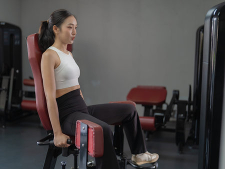 Portrait of a young beautiful Asian woman working out at the gym