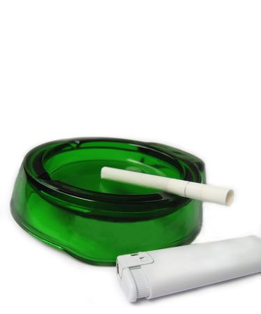 White cigarette and lighter emerald ashtray on a white backgroundの写真素材