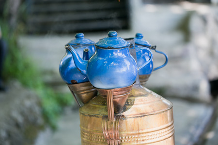 Blue teapots placed above copper samovarの写真素材
