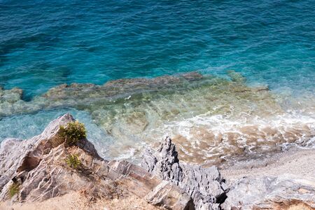 Turquoise sea with pristine waters and rocky bottom at Ulash Beach in Alanya Turkeyの写真素材