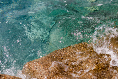 Fragment of pristine turquoise sea water and rockの写真素材