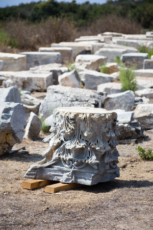 fragment of carved marble column with pieces of other columns as blurred background in Antiochia ad Cragum Gazipasha and Alanya Turkeyの写真素材