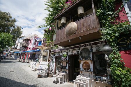 KALKAN, TURKEY - MAY 22 Storefront of antique shop decorated with shelves with antique metal trays jugs lanterns and other souvenires on cobblestone paved narrow streets of Kalkan 216のeditorial素材