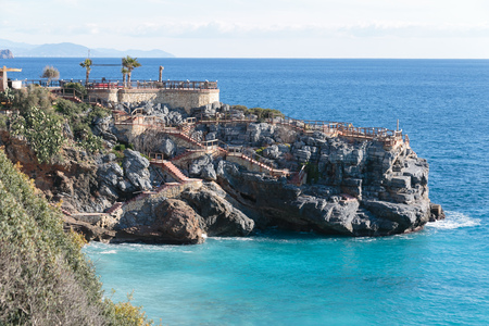 seascape with cafe located on rock shot on sunny day in Alanyaの写真素材